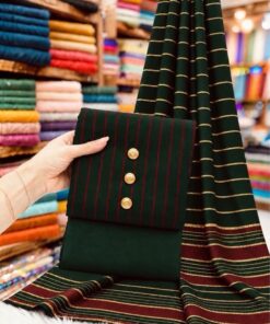 A flat-lay showcase of unstitched check pattern winter suit PR-143 by Abu Hurairah Fabrics, featuring deep indigo and rust-orange plaid fabric alongside a branded craft tag on a wooden surface.